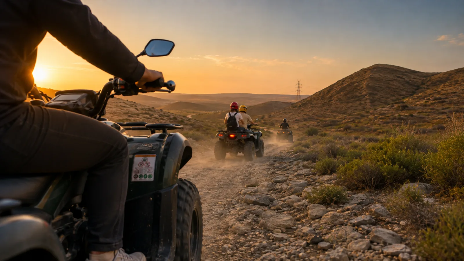 Riders following a rocky dusty track through the Absheron hills at sunset